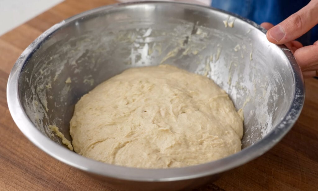 fermented dough in silver bowl