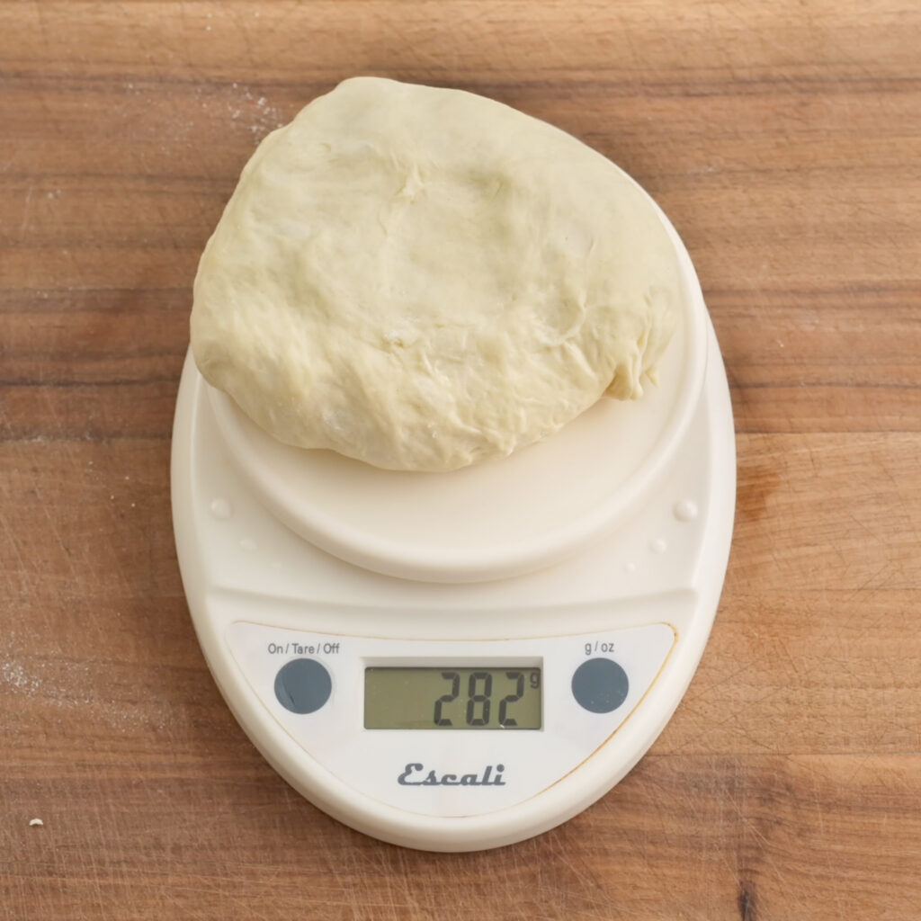280g ball of dough on white kitchen scale