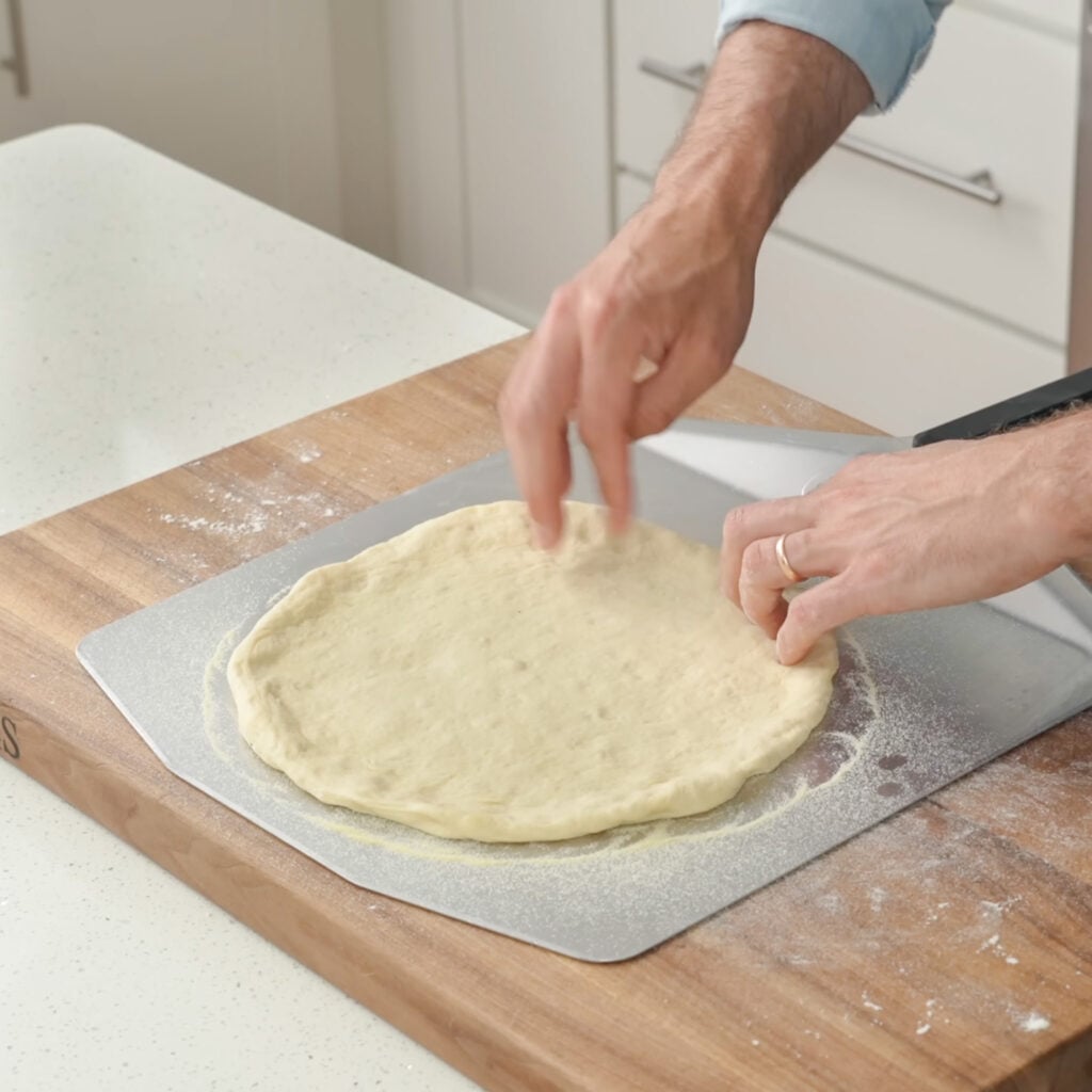 pizza dough on semolina dusted p pizza peel