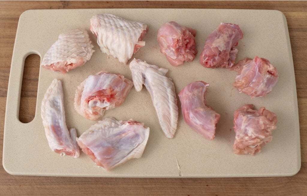 turkey wings and neck pieces cut on cutting board