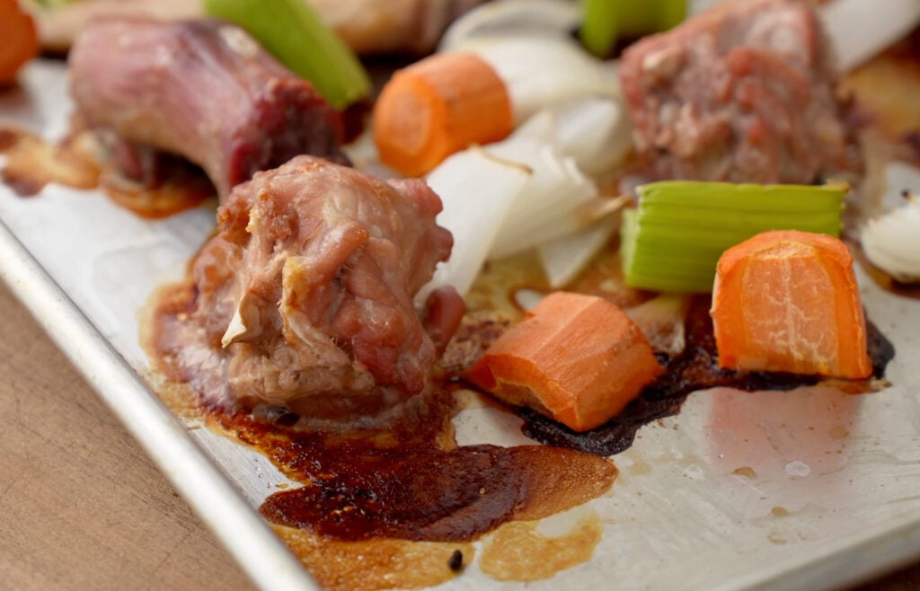 roasted turkey wings neck carrot celery onion on sheet pan