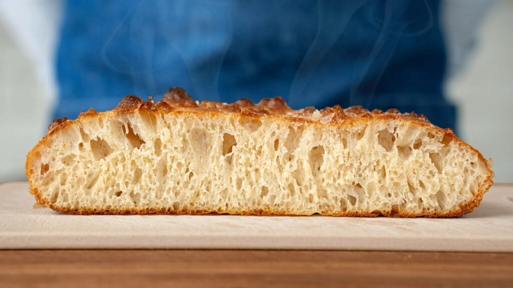 sliced focaccia bread with steam rising
