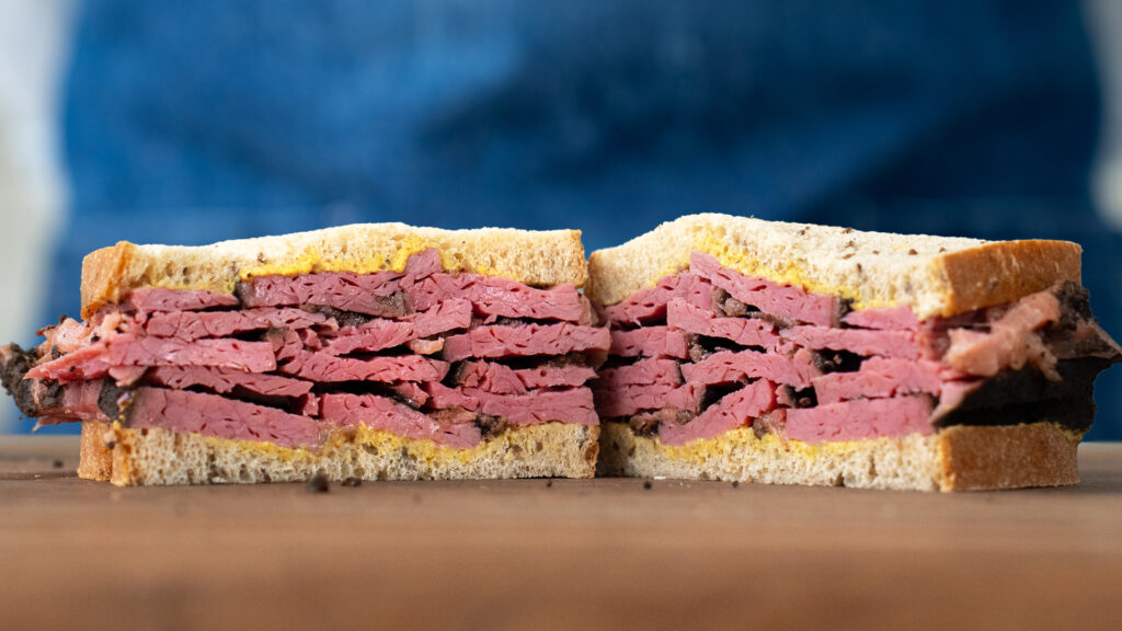 pastrami on rye sandwich with blue apron
