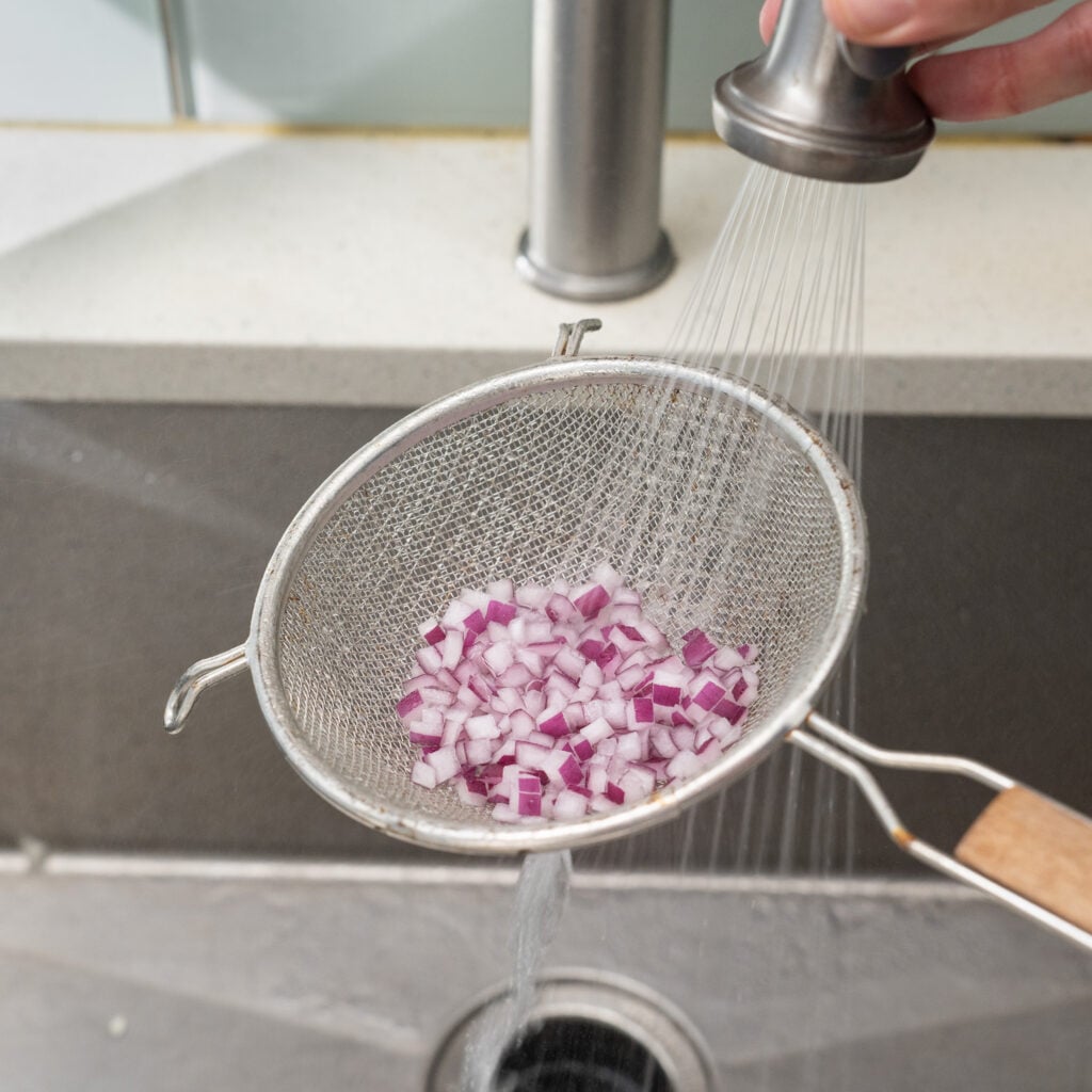 rinsing red onion under water