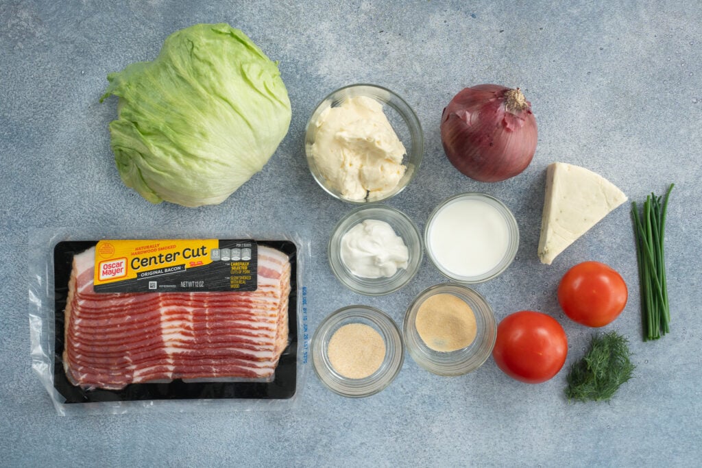 ingredients used to make wedge salad arranged on grey background