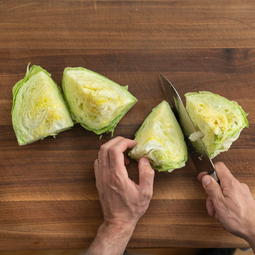 cutting iceberg wedges on wooden cutting board