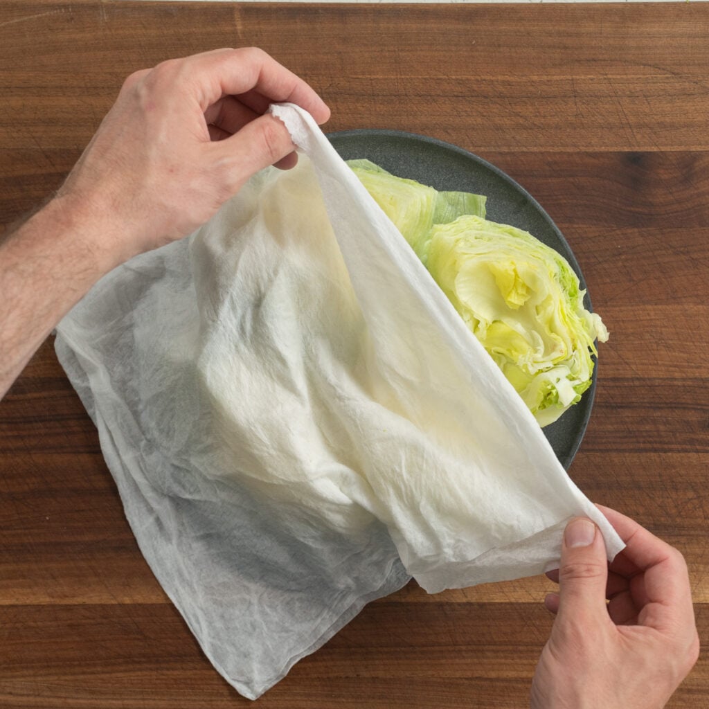 covering iceberg lettuce wedges with damp paper towel