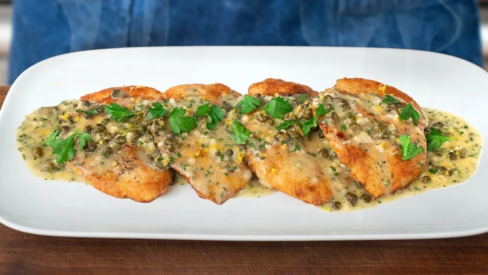 chicken piccata on a white serving tray