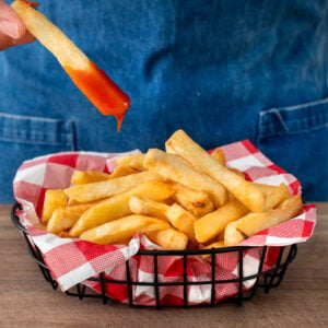 basket of French fries in red checkered cloth