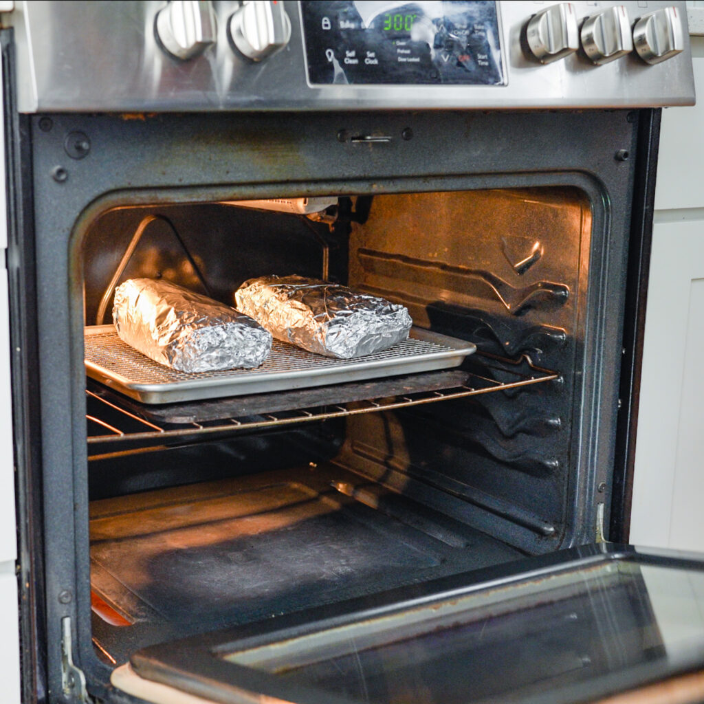 pastrami wrapped in foil in an oven