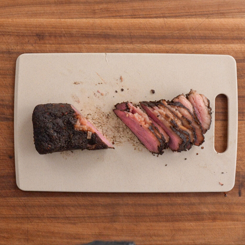 sliced pastrami on a cutting board