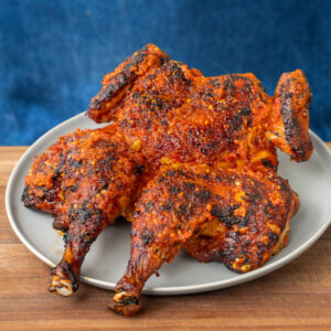 peri peri chicken on a grey plate