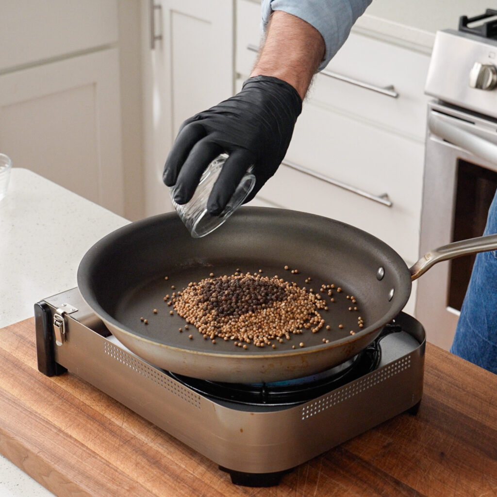 adding peppercorns toasted nonstick pan