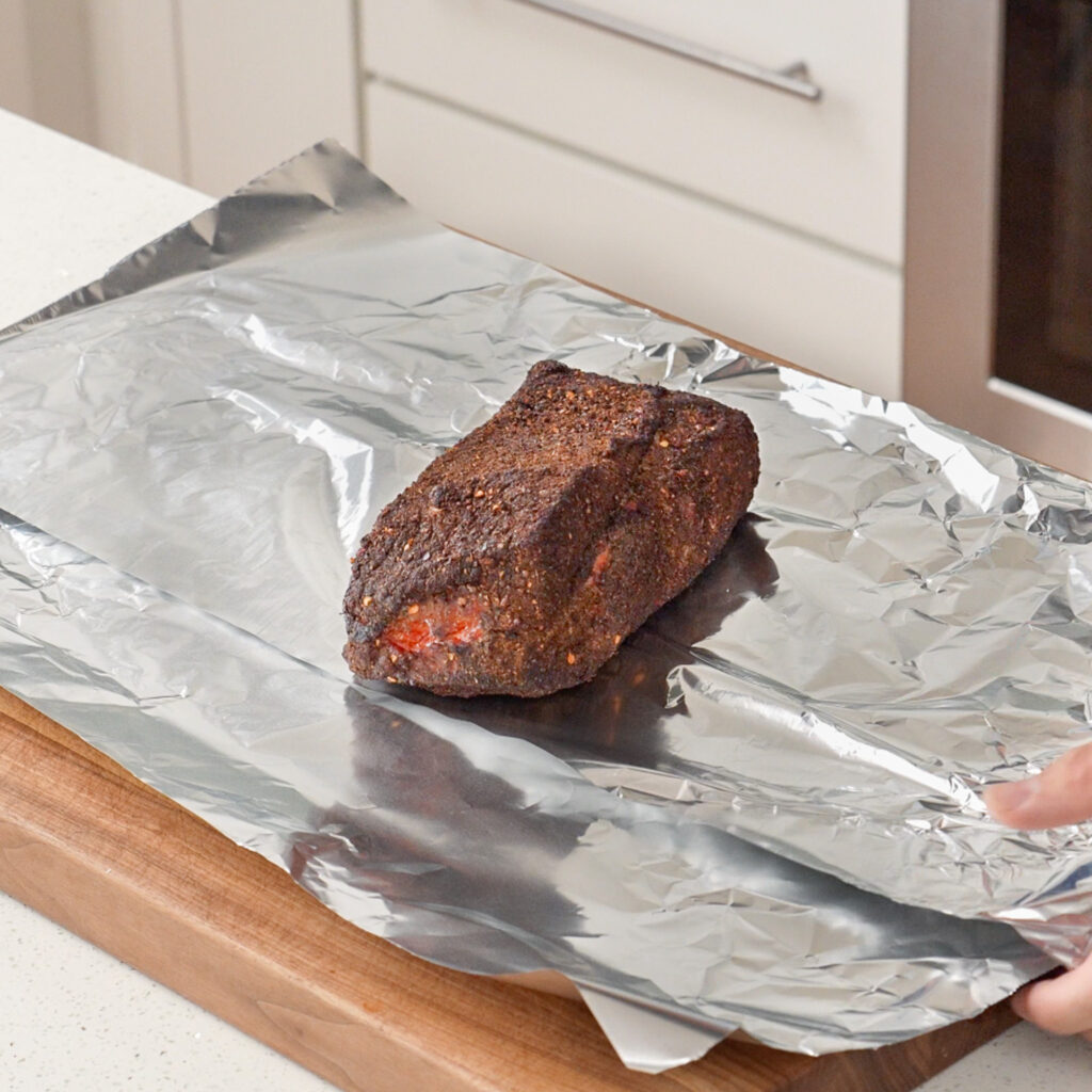 smoked pastrami on a sheet of aluminum foil