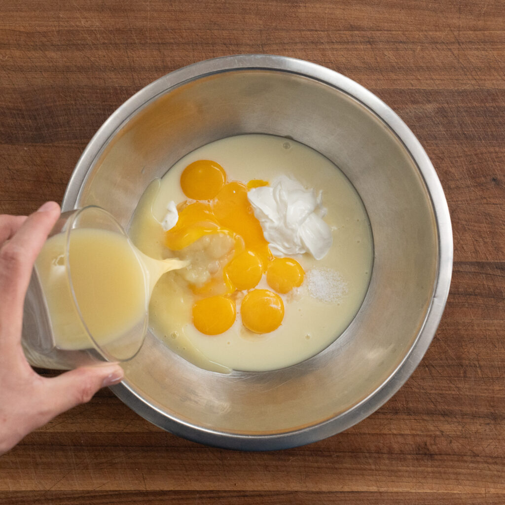 adding key lime juice to key lime pie custard
