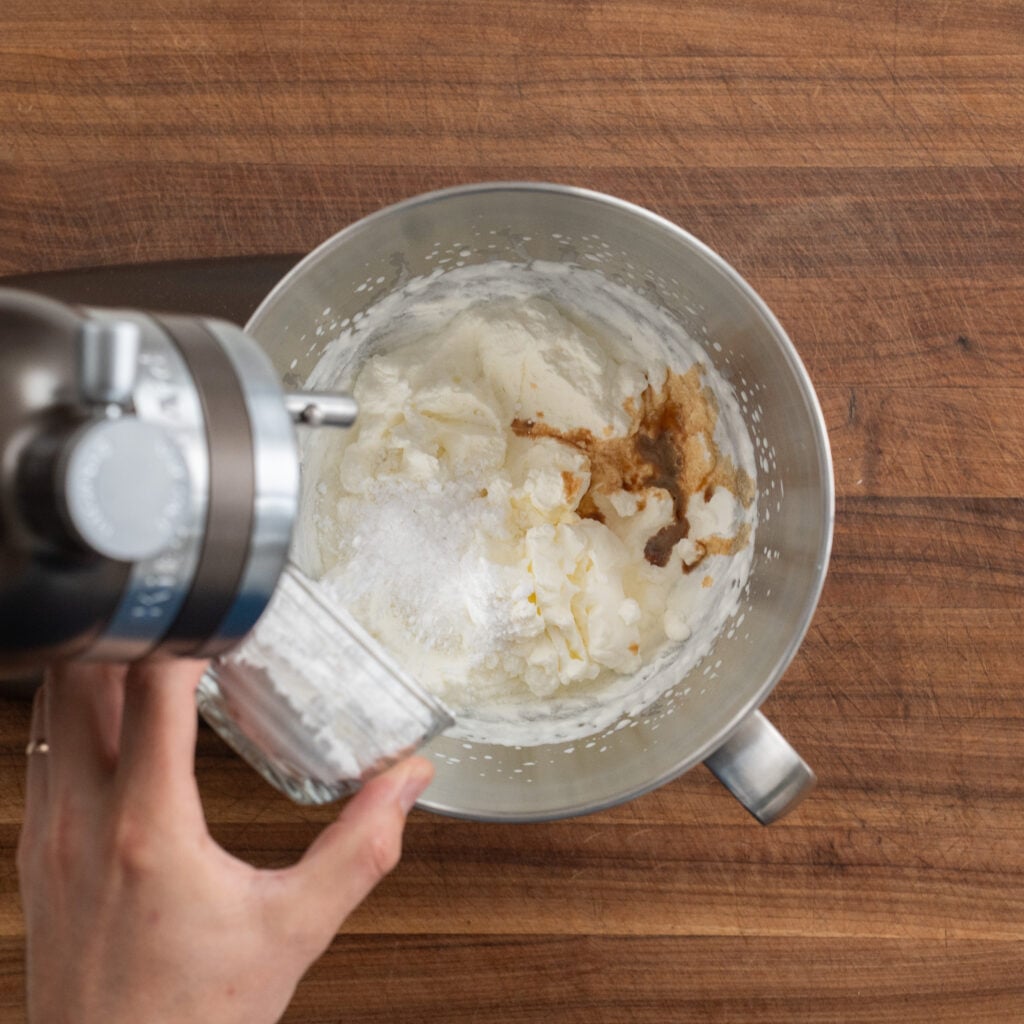 adding sugar and vanilla to whipped cream