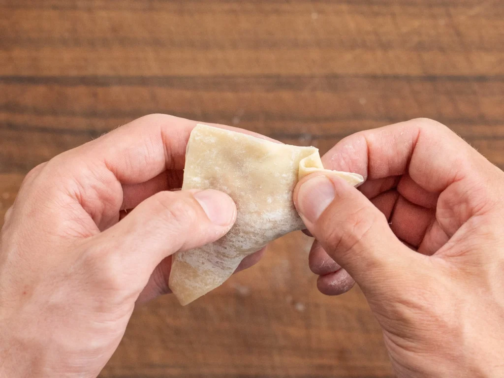hands crimping wonton