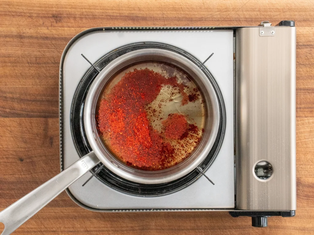 gochugaru and oil in a sauce pan