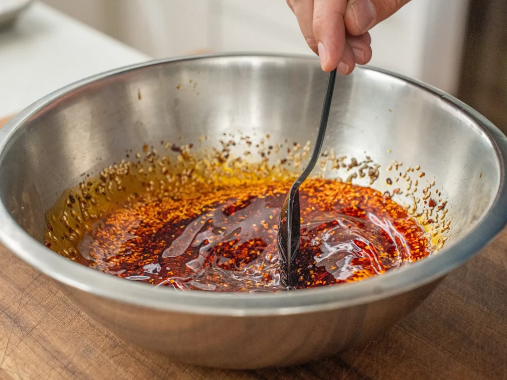 stirring hot chili oil with black spoon