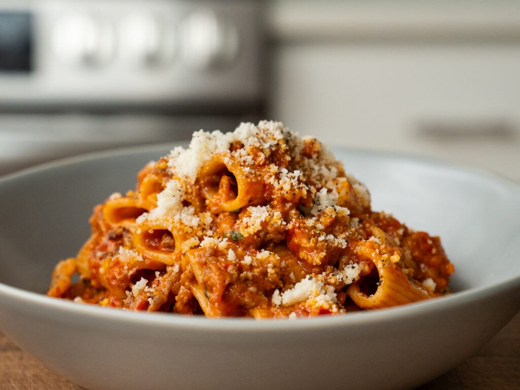 spicy sausage rigatoni piled in grey bowl