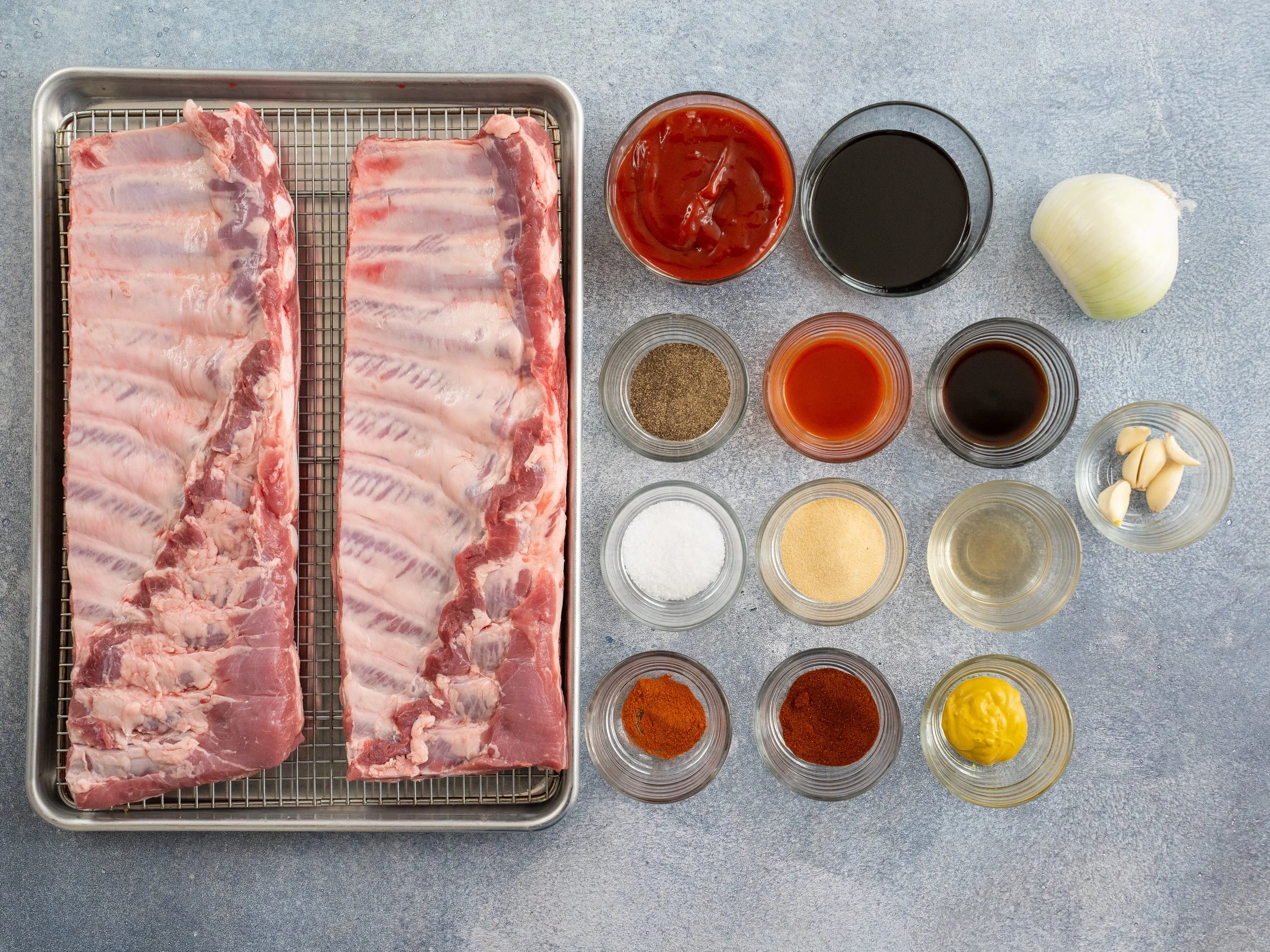 2 slabs st louis ribs on left bbq sauce ingredients in containers on right