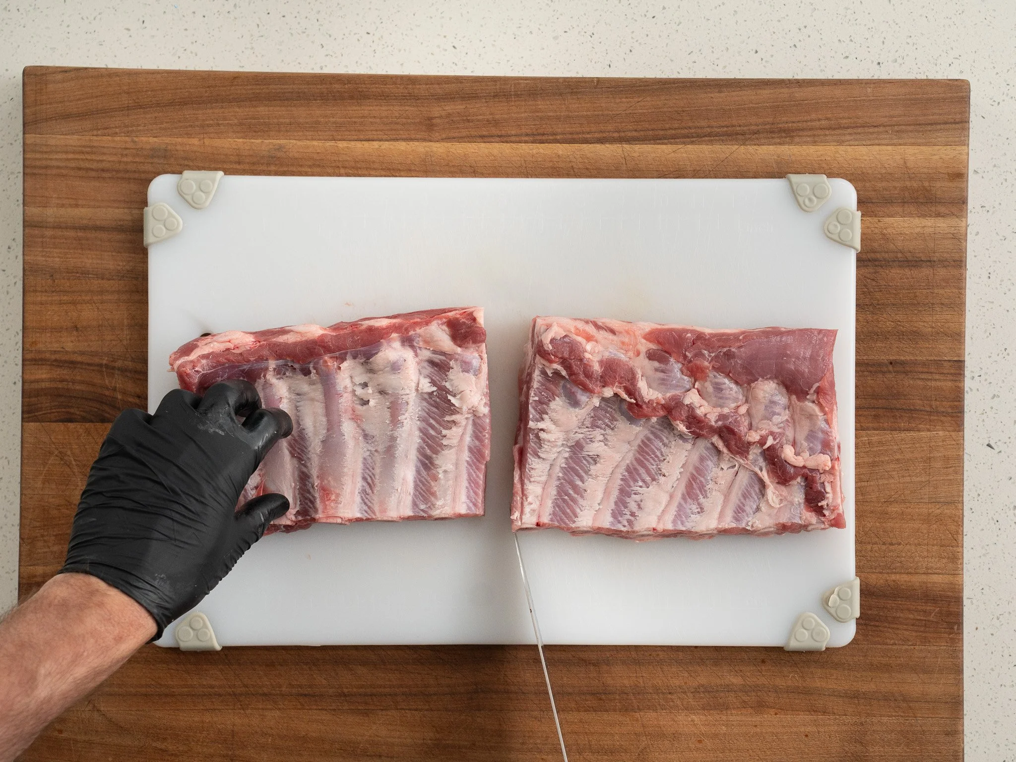 slicing rack of st Louis ribs in half
