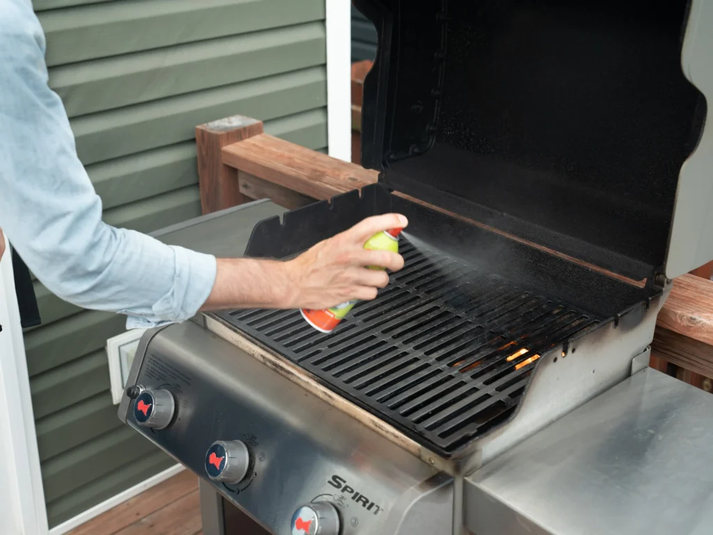 spraying oil onto grill grates