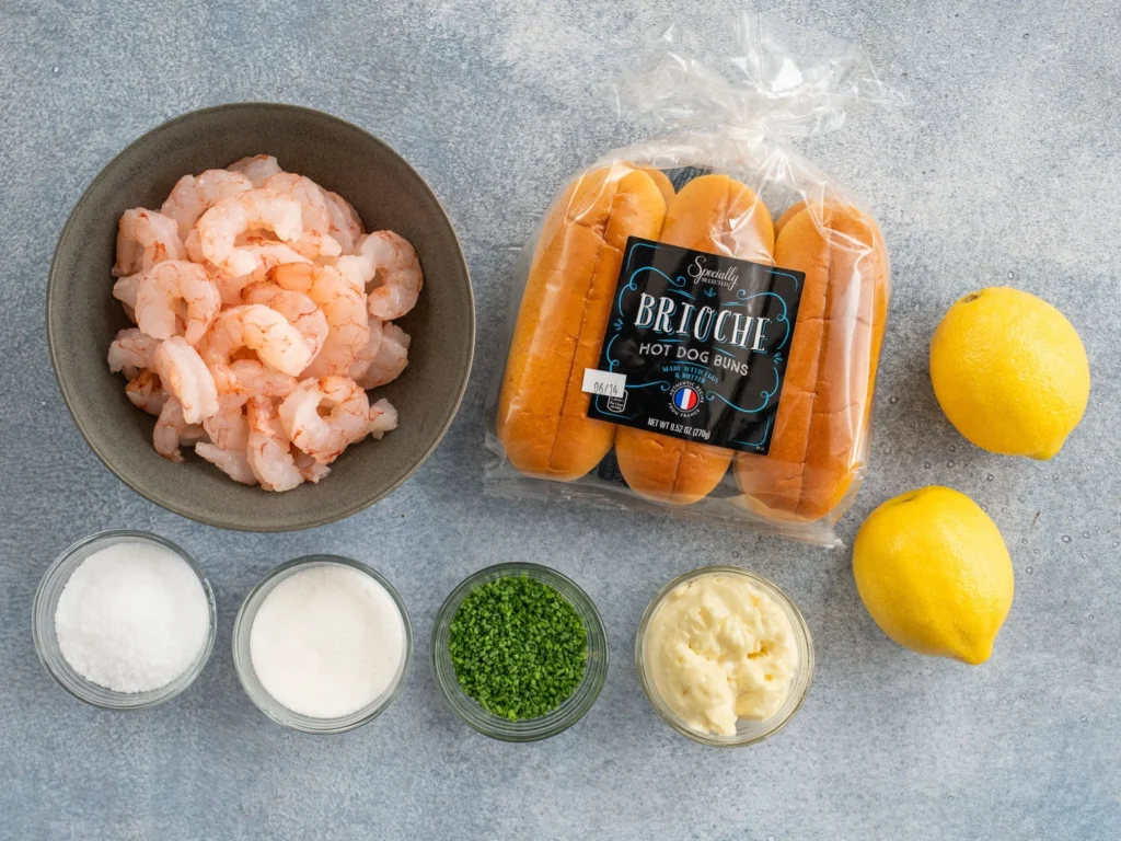shrimp brioche buns lemons salt sugar chives mayo on a grey background