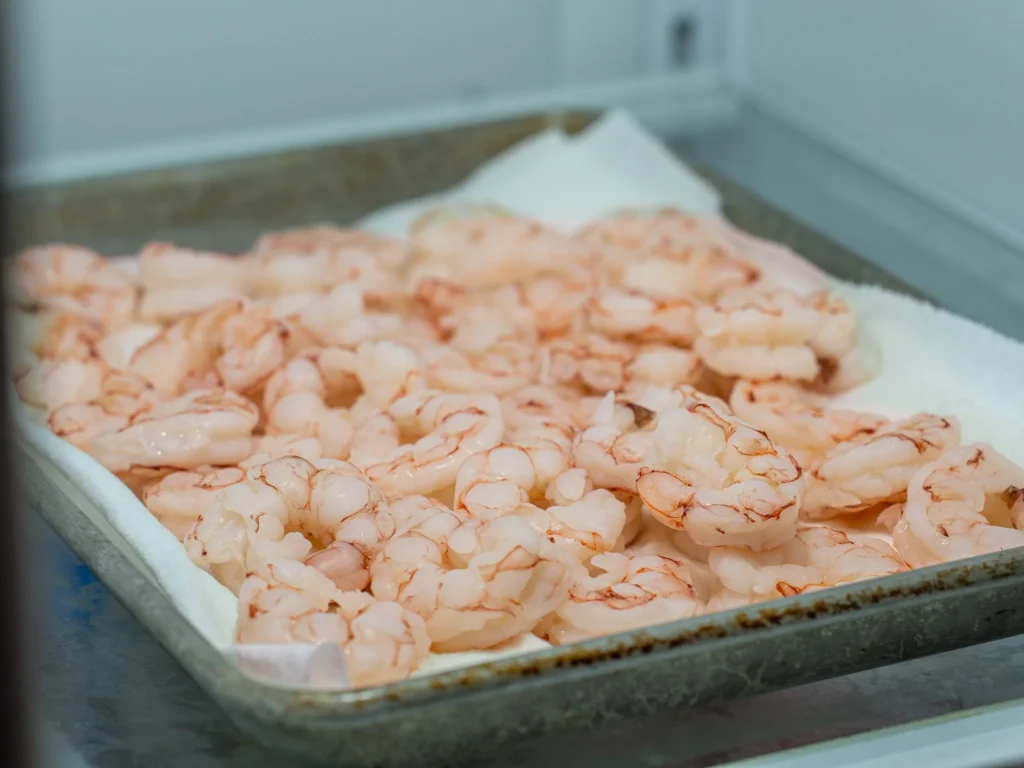 cooked shrimp on paper towel lined tray