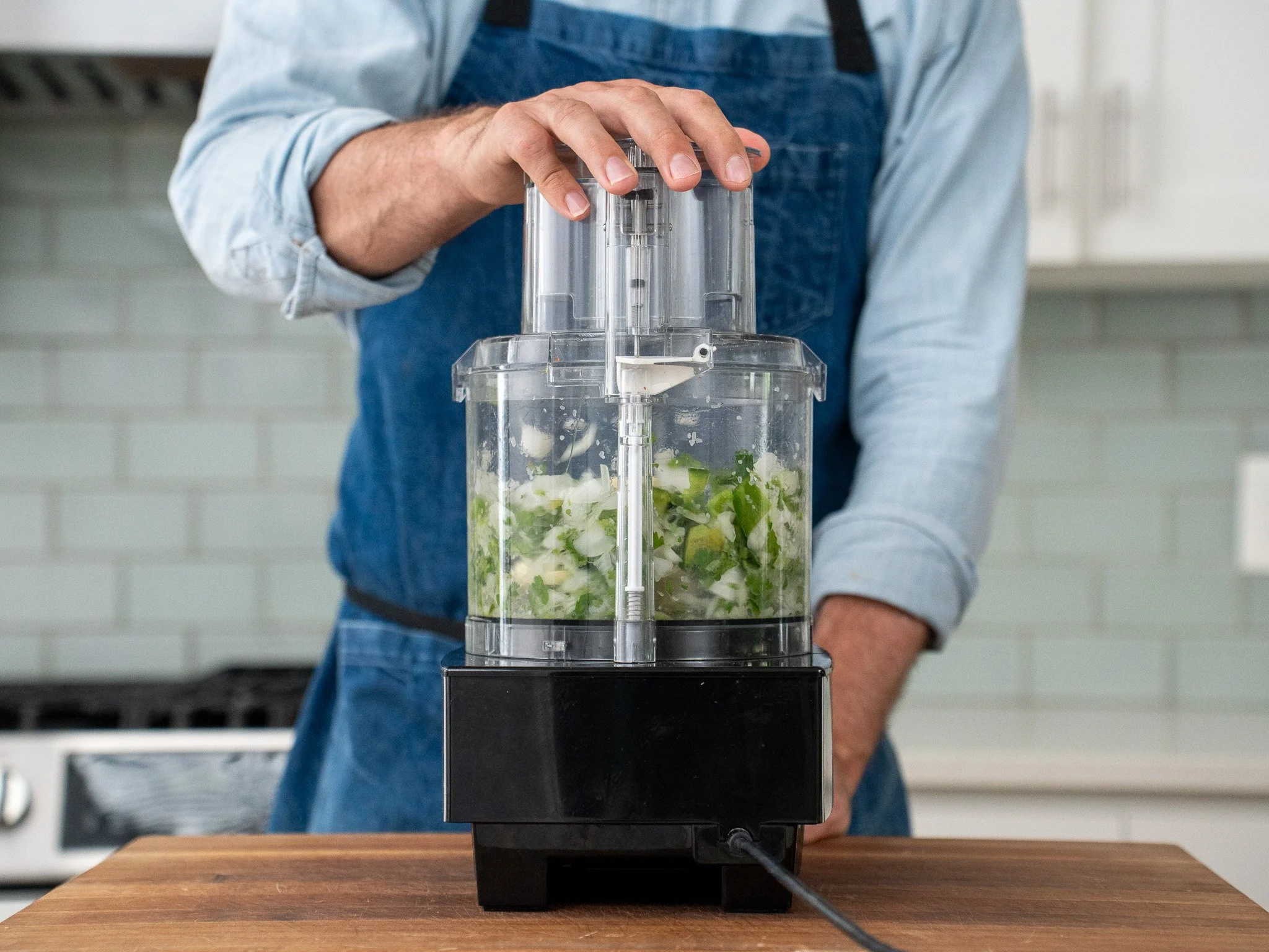 onion jalapeno cilantro being pulsed in food processor