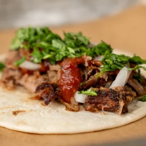 pork carnitas taco with red Chile salsa cilantro onion