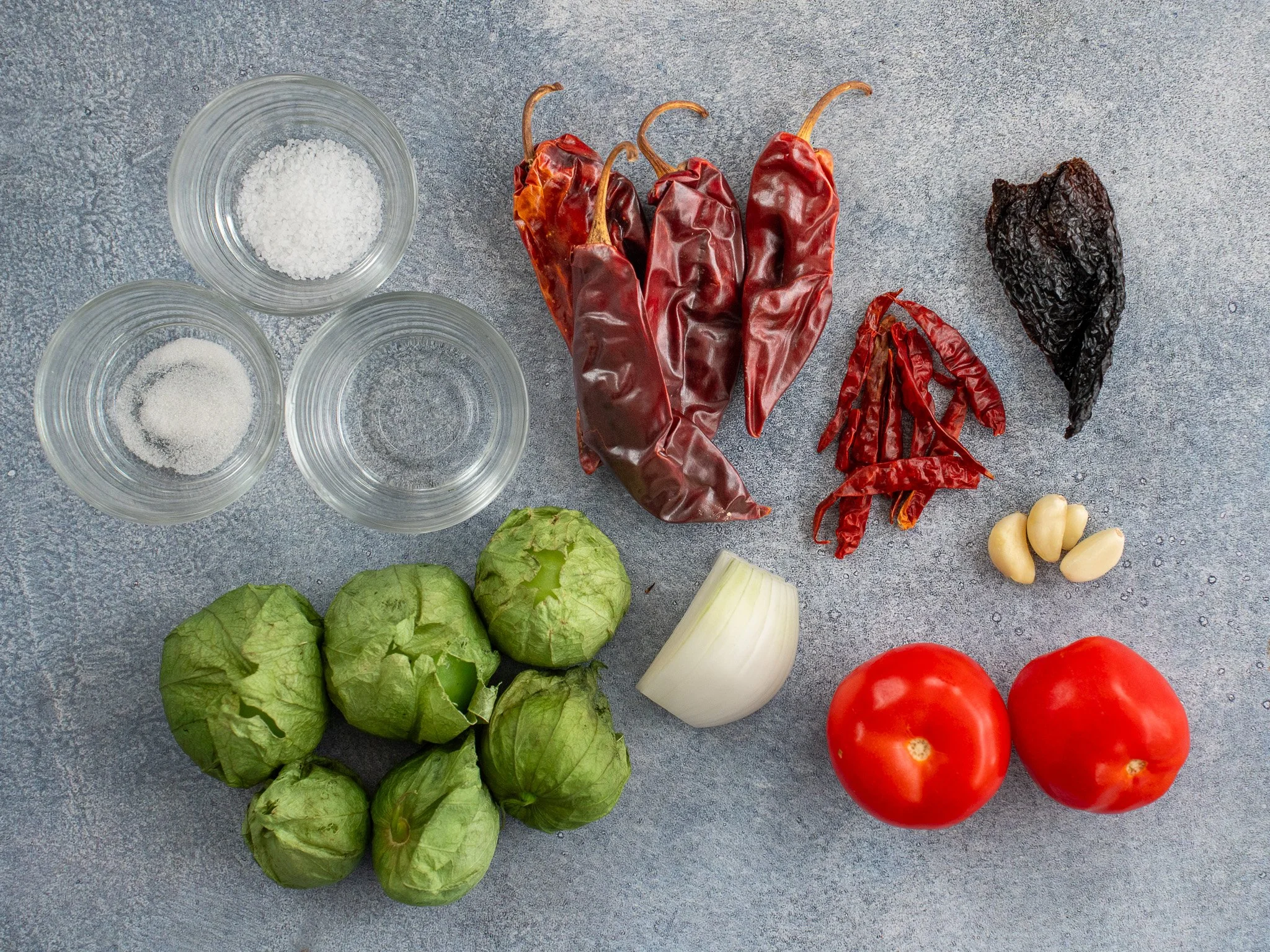 ingredients to make salsa taqueria on grey background