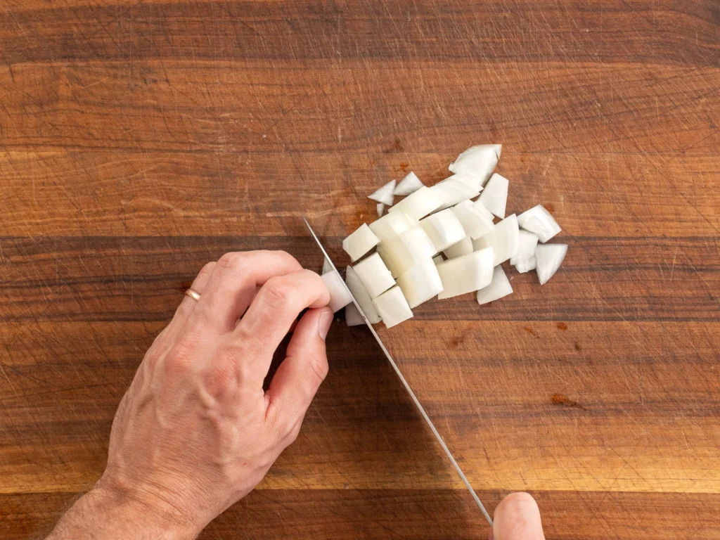 chopping onions on wood cutting board