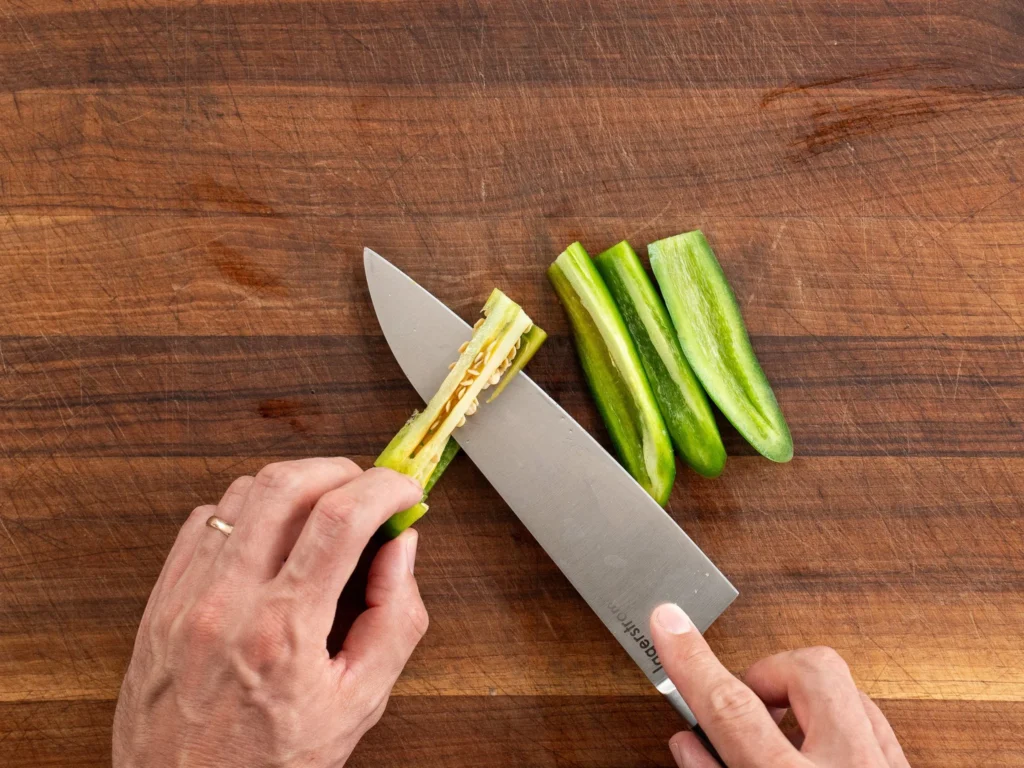 knife removing ribs from jalapeno