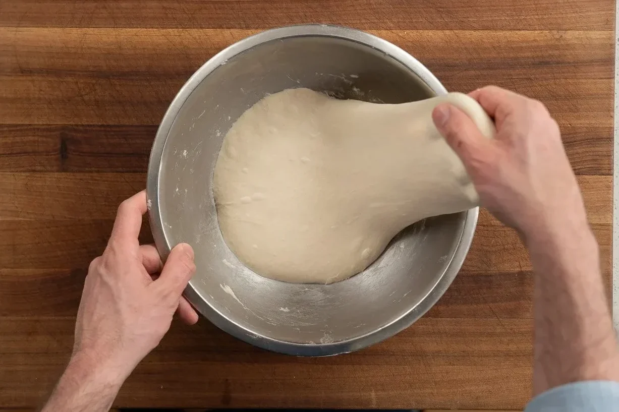 performing stretch and fold on focaccia dough