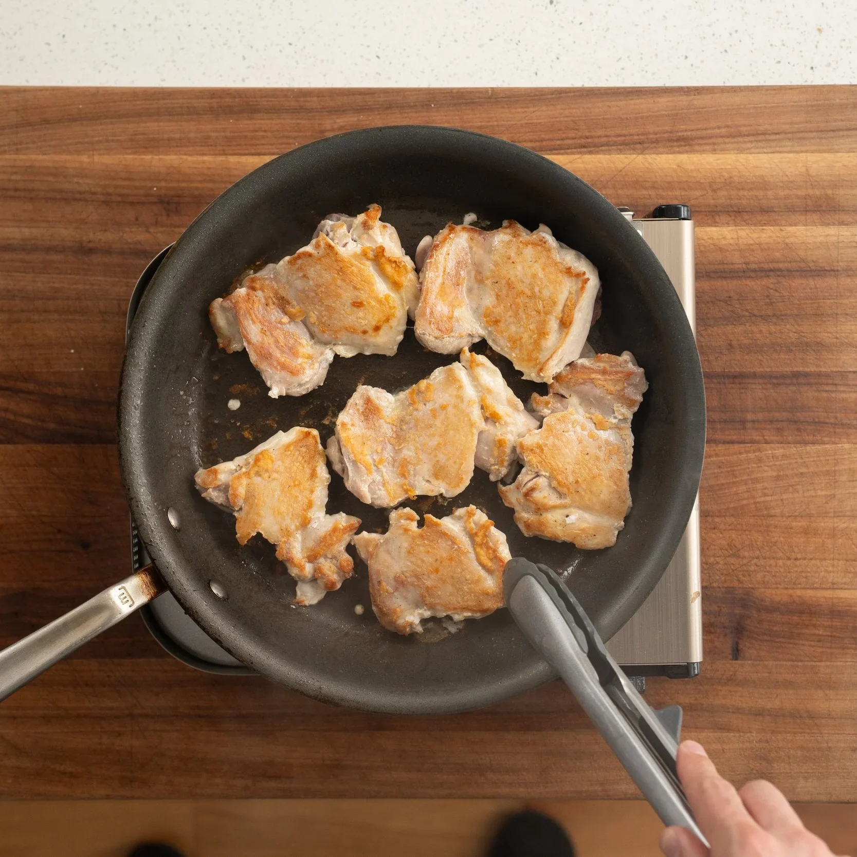 browning chicken thighs in frying pan