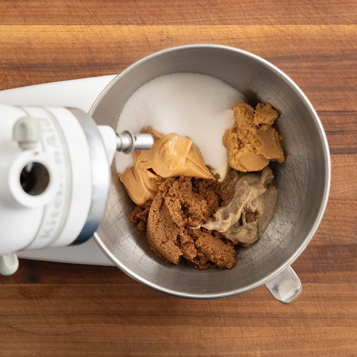 peanut butter cookie ingredients in the bowl of a stand mixer
