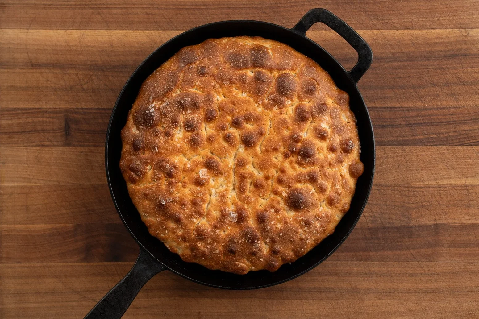 baked golden brown focaccia in cast iron pan