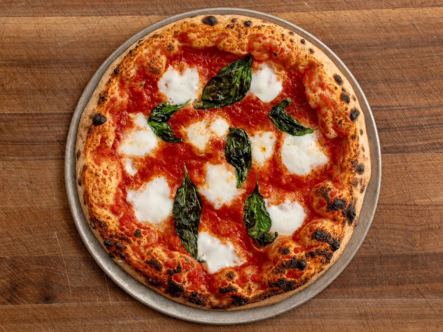 baked Neapolitan pizza on wooden cutting board
