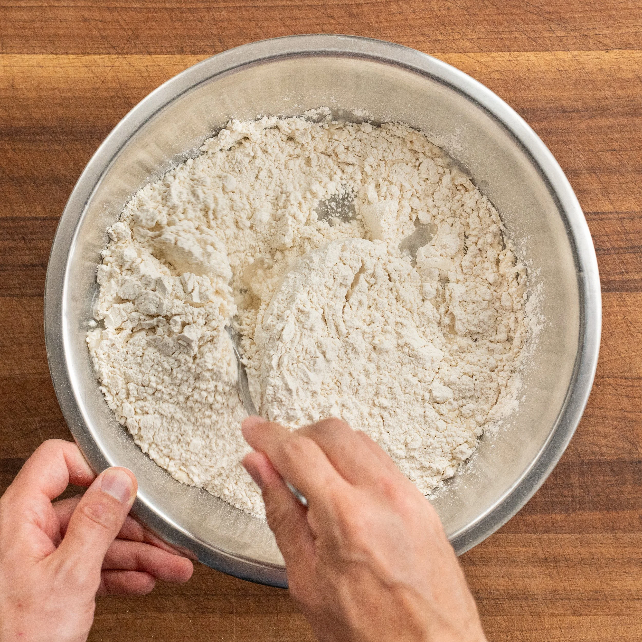 spoon stirring flour into yeast water