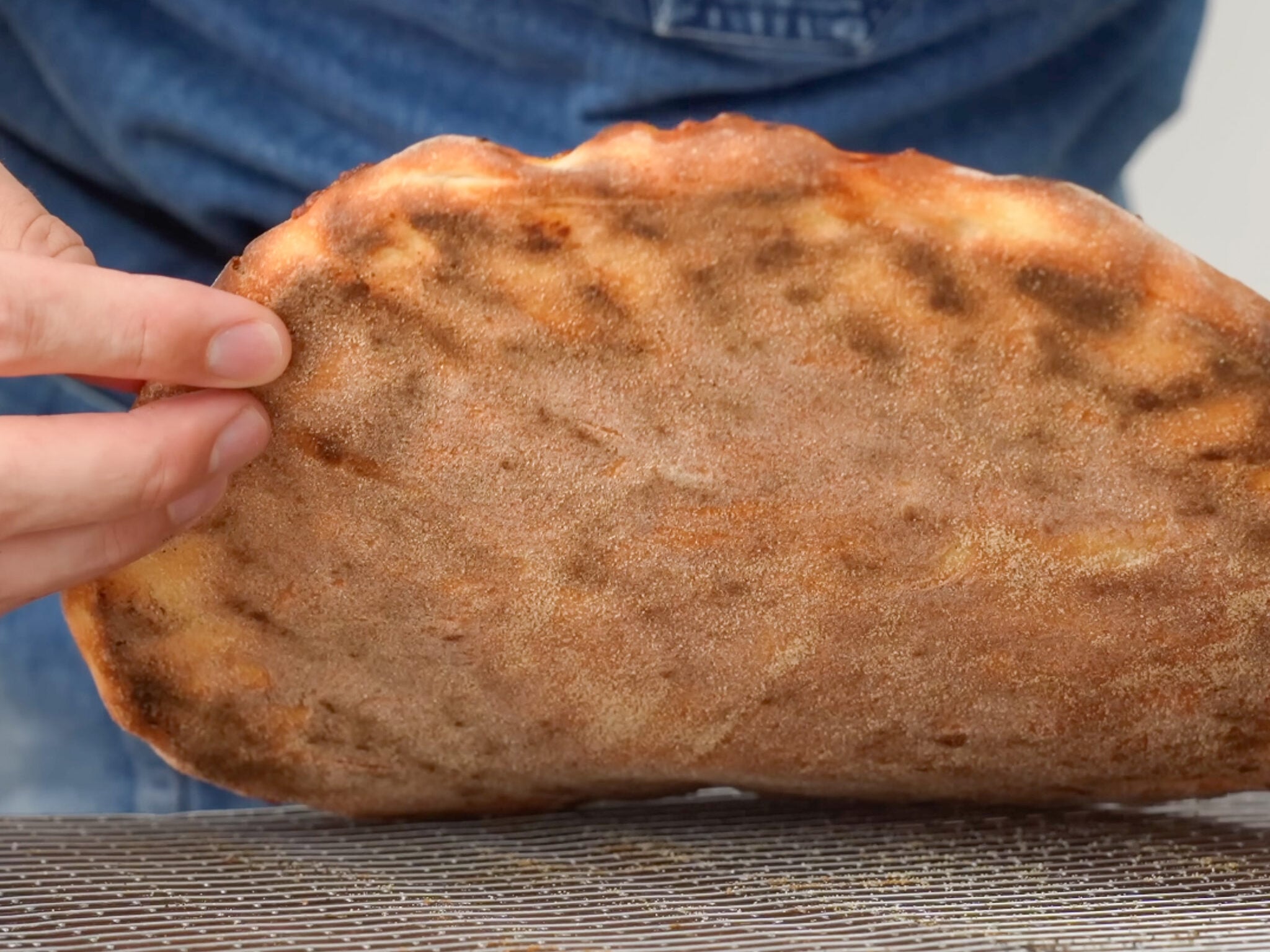 browned bottom of fresh baked pizza