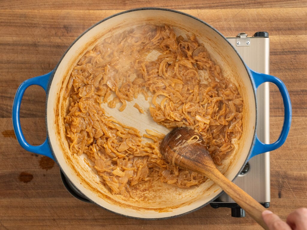 browned caramelized onions in blue dutch oven