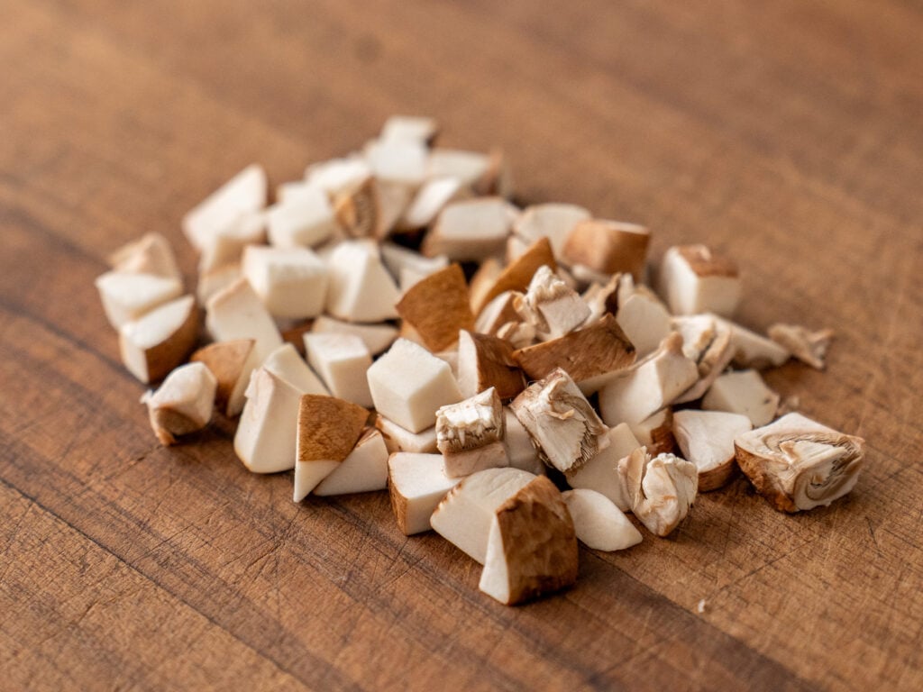 diced mushrooms on wood board