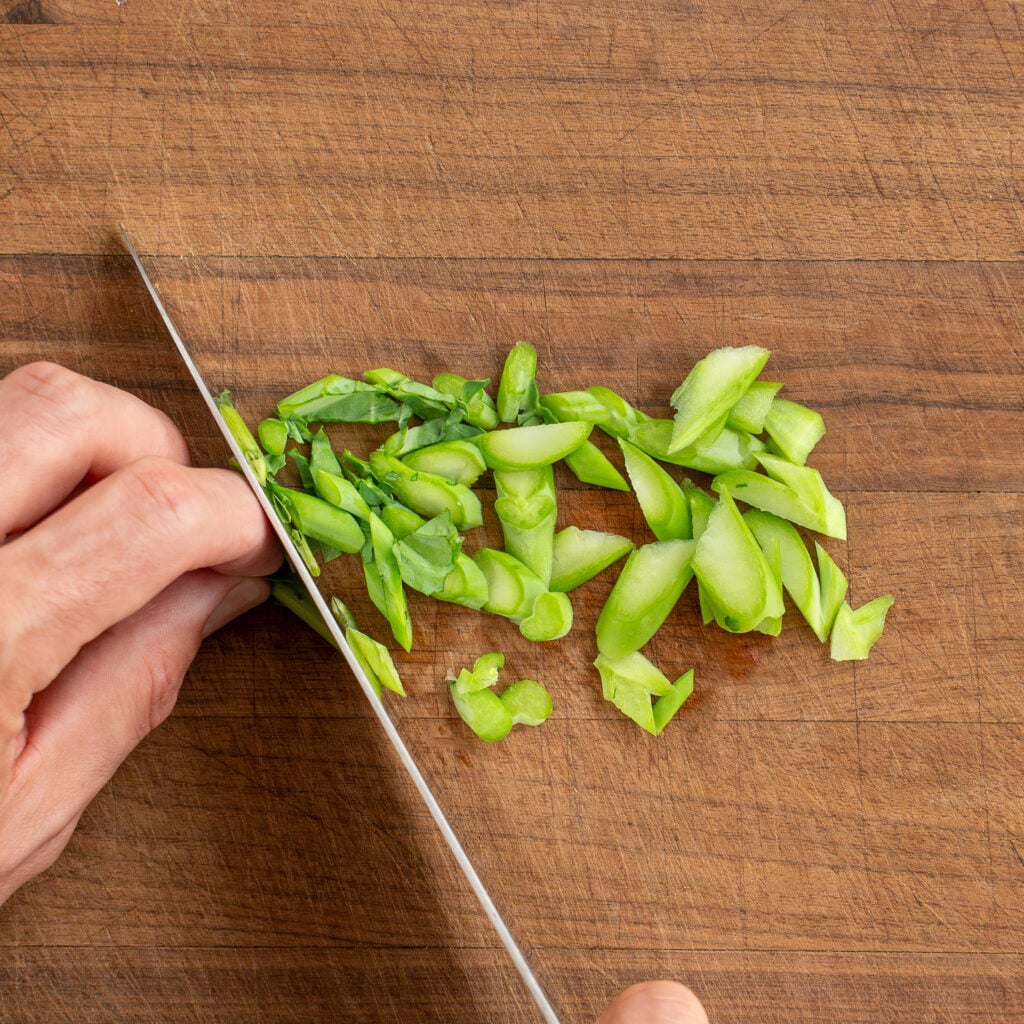slicing Chinese broccoli stems on a bias