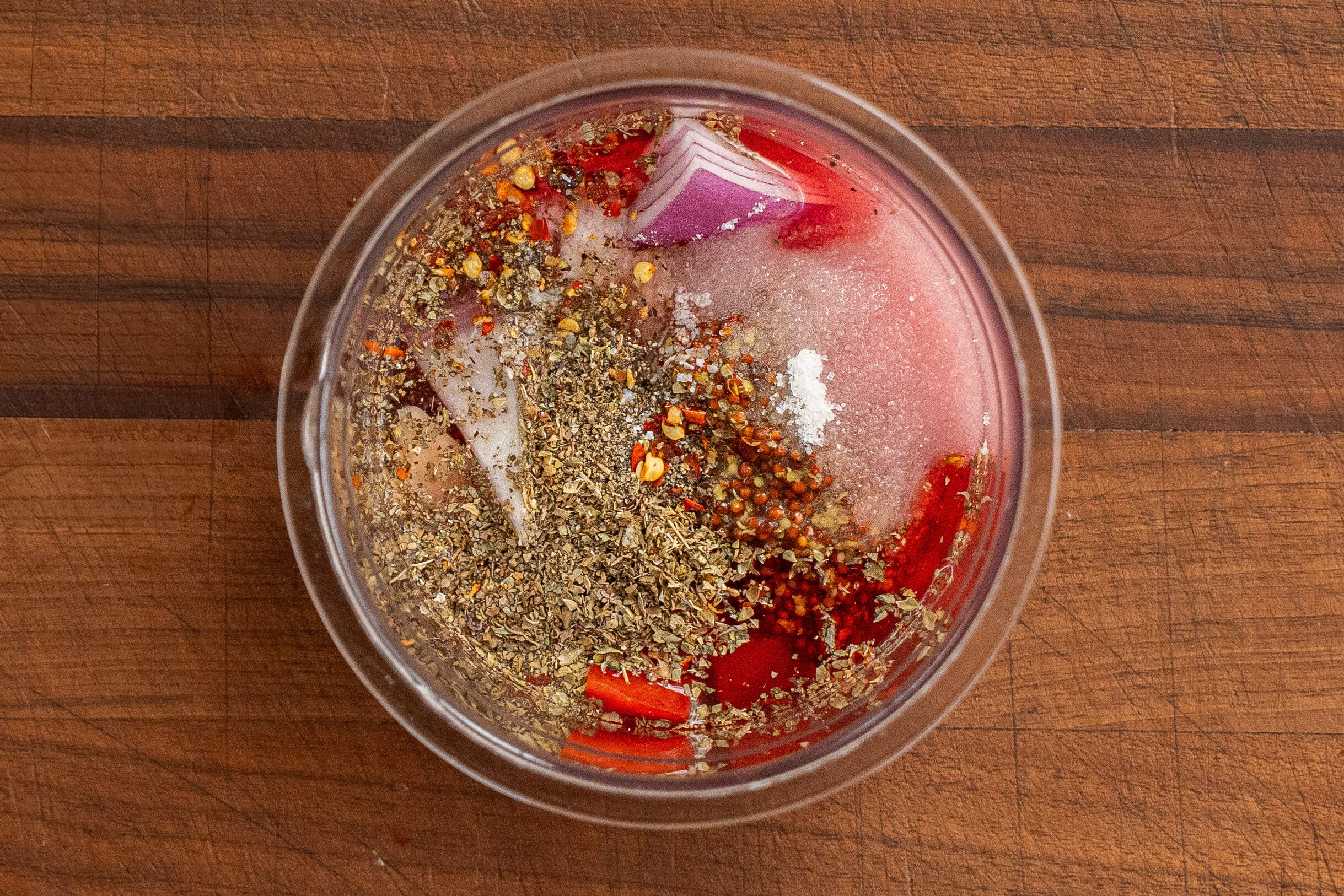 italian dressing ingredients in clear container from overhead