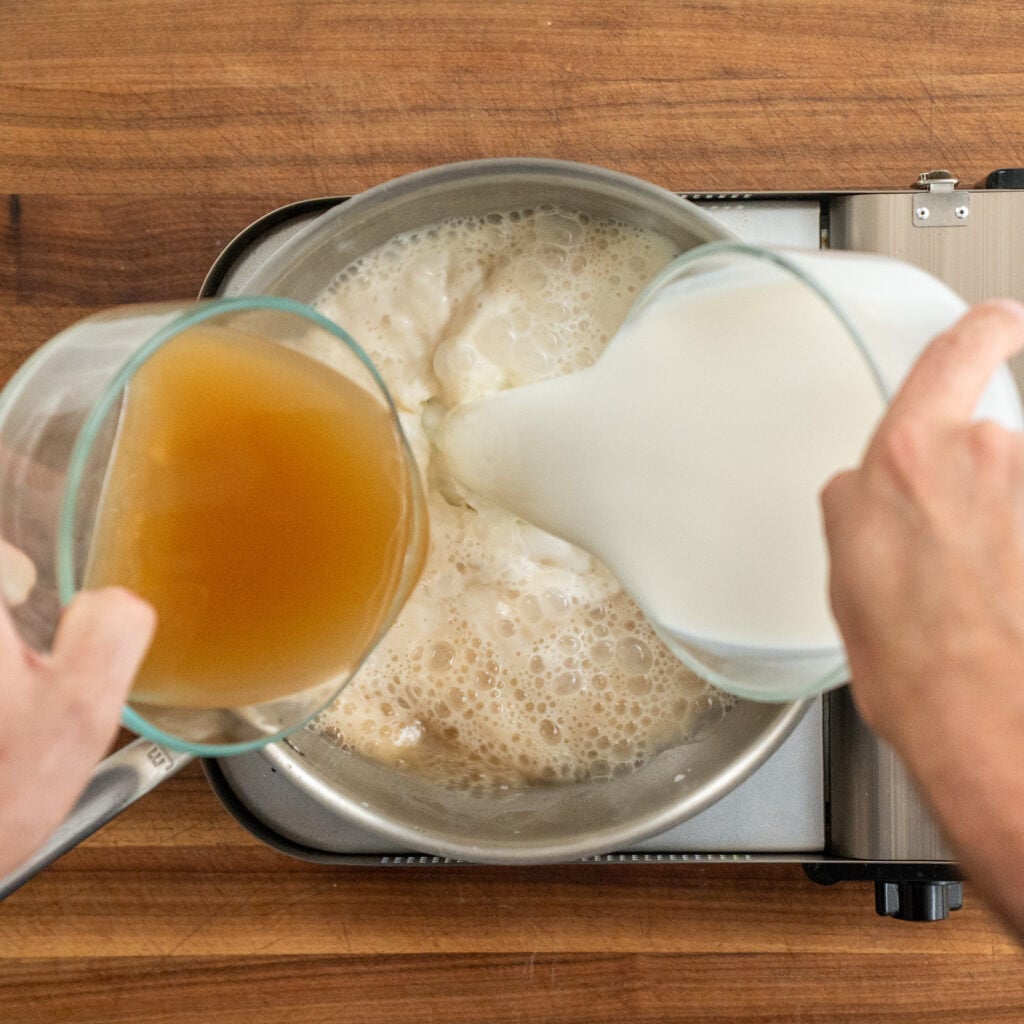 adding milk and chicken stock into sauce pot