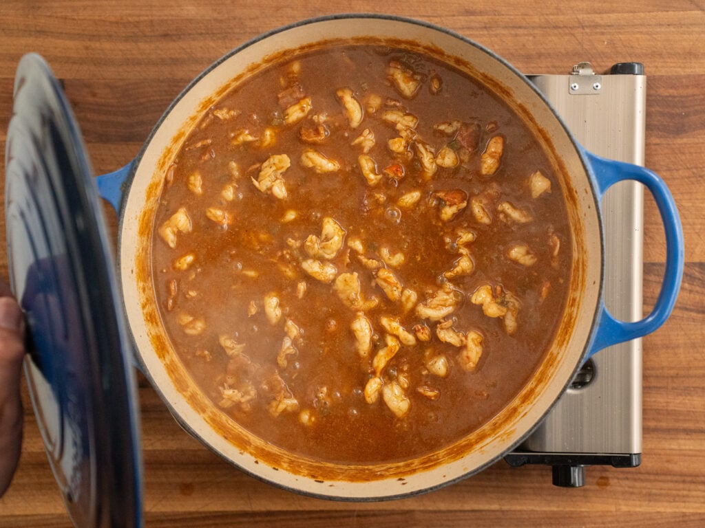 blue dutch oven filled with shrimp gravy