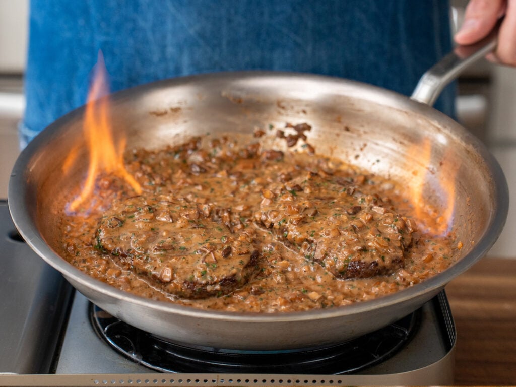flaming Steak Diane in stainless saute pan