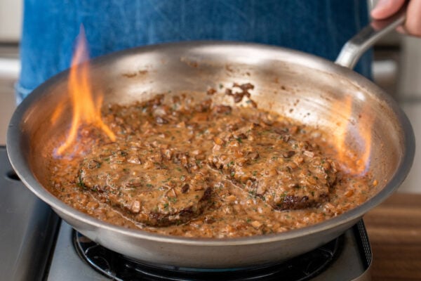 flaming Steak Diane in stainless saute pan