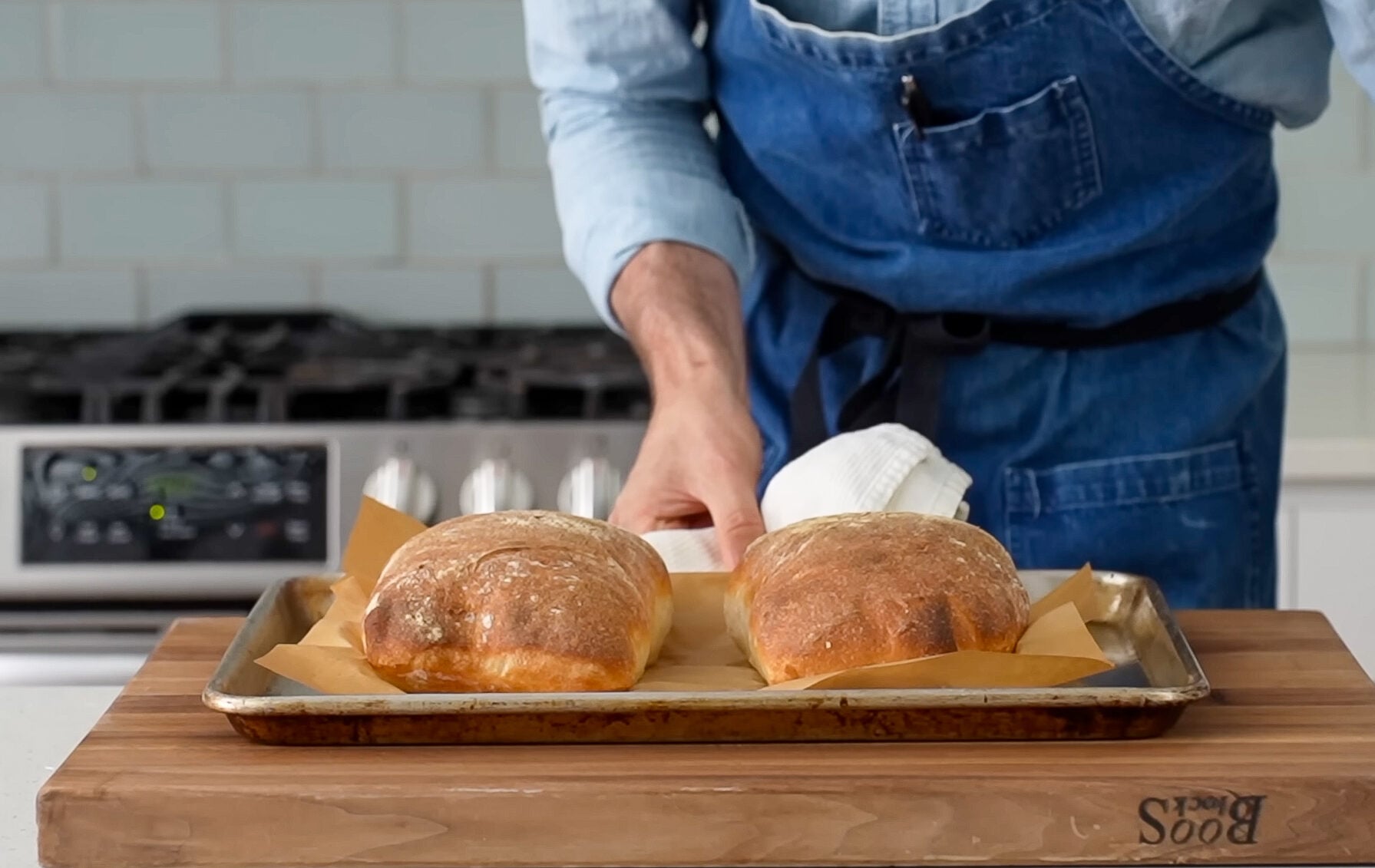two baked loaves of bread on sheet tray